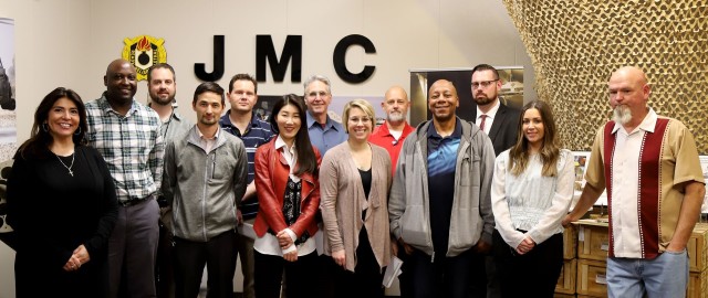 Thirteen new JMC employees pose inside the JMC display room after completing the three-day AMPED training. 