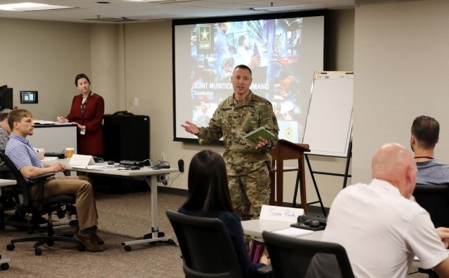 Col. Todd Burnley provides opening remarks and welcomes new JMC employees during the recent AMPED session.