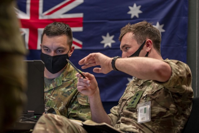 Australian Army Captain Chris Wetherell (left) from the 7th Combat Brigade works with Captain Freddie James from the 1st Armored Infantry Brigade, British Army, during the Joint Warfighting Assessment (JWA) 2021 at Fort Carson, Colorado. Events like JWA and Project Convergence facilitate information-sharing with joint and coalition partners to enable a common operating picture and sensor-to-shooter connectivity. (Photo by Cpl. Nicole Dorrett)