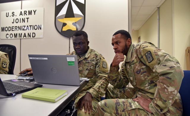 2nd Lt. Richard Bioh, left, and Cpl. Keondray Washington, both of the 86th Expeditionary Signal Battalion, work on the network May 20, 2022, at Joint Modernization Command, Fort Bliss, Texas, during an early communications exercise for Project Convergence 22. The 86th ESB has been tasked to support Project Convergence 22 and has become an important part of the Network team. (Photo Credit: Jay Koester/Joint Modernization Command)