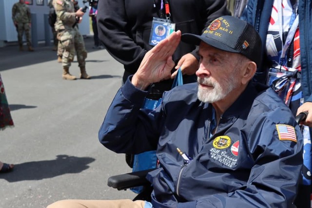 Bill Casassa, a U.S. Army veteran who served with the 638th Tank Destroyer Battalion, 84th Infantry Division, renders a salute. 