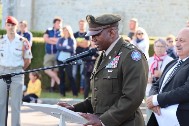 Col. Mark Denton, commander, 207th Military Intelligence Brigade – Theater, speaks during a ceremony that commemorates and honors the men of Easy Company, 506th Parachute Regiment, 101st Airborne Division who lost their lives when their C-47 aircraft was hit by enemy fire in June of 1944, Sainte Mere Eglise, Normandy, France, June 2.