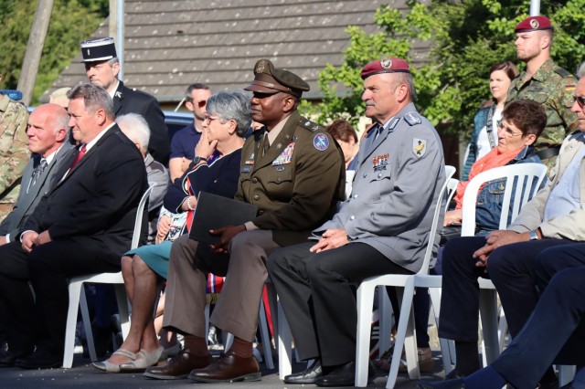 Col. Mark Denton, commander, 207th Military Intelligence Brigade – Theater, seated in the center, listens intently during a ceremony that commemorates and honors the men of Easy Company, 506th Parachute Regiment, 101st Airborne Division who lost...