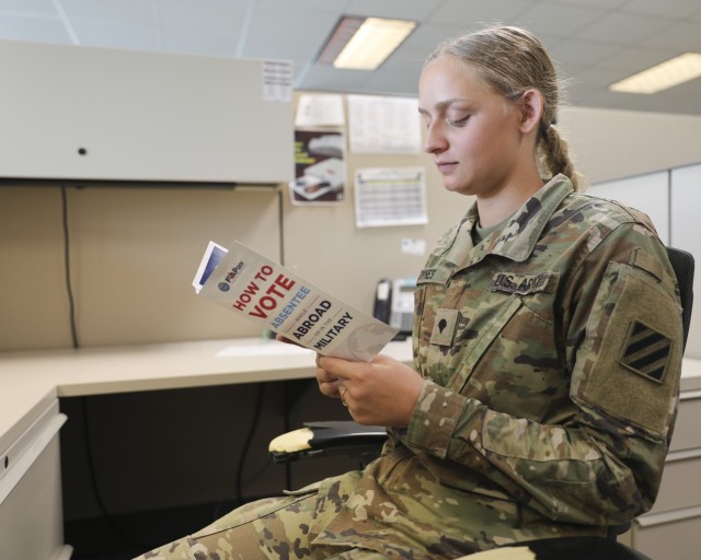 Dogface Soldier reads the FVAP handbook