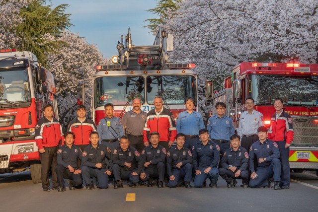 Members of the U.S. Army Garrison Daegu Fire and Emergency Services team pose in front of fire trucks at Camp Walker, Republic of Korea, April 1, 2022. The firefighting team won the Department of the Army&#39;s Medium Fire Department of the Year and Fire Chief of the Year awards for 2021.