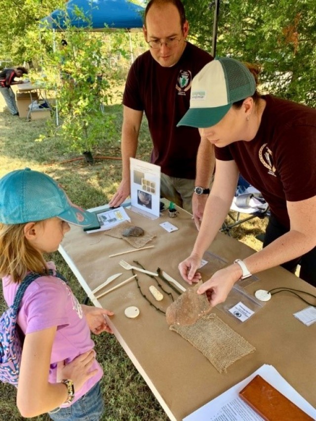 Program staff participating in an outreach event. Hands on activities are encouraged to make learning about archaeology fun and engaging. Using artifacts from Fort Campbell as teaching aids, participants of all ages get to touch a piece of the past.