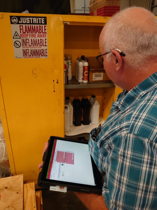 The tablet in use during a Multi-media environmental compliance inspection.  For field use, the tablet is fitted with a rugged case and hand-held strap.  The image on the tablet screen represents one of the inspection questions.