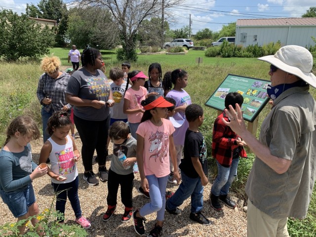 Charlie Plimpton, biologist, educates youth at a STEM summer camp session held at the Fort Hood Pollinator Sanctuary, July 15, 2021. Throughout the year, the team conducts numerous environmental education programs for Soldiers, civilians, families, and youth on and off the installation, which directly impacts more than 3,500 individuals annually. Regularly participated school and public events include Keep Copperas Cove Beautiful Eco-Harvest, Make a Difference Day, Fort Hood Christmas Bird Count, National Night Out, Fort Hood Earth Day, City of Gatesville Earth Day, National Girl Scout Week, and FRIENDS Youth Environmental Ambassadors! Program.