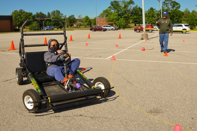 Fifteen-year-old Thomas Walters attempts to complete a driving course in a simulated impaired driving experience, or SIDNE, provided by the Army Substance Abuse and Prevention Program during the Army Heritage exhibition Friday at Nutter Field House.