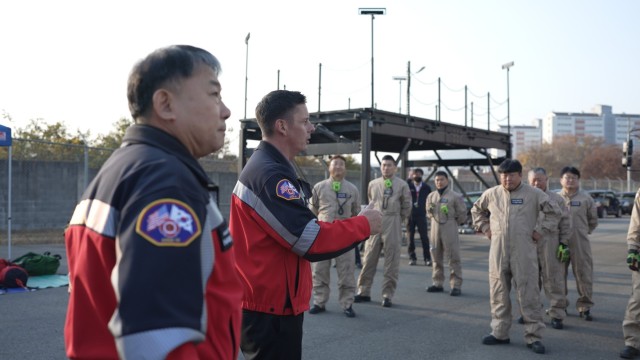 U.S. Army Garrison Fire and Emergency Services Fire Chief Mike Diehl (second from left) briefs his firefighters during a live burn training event at Camp Carroll, Republic of Korea, November 18, 2021. Diehl was recognized as the Department of the Army&#39;s Fire Chief of the Year for 2021.