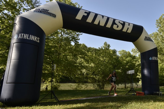 Army spouse Jenni Sherman crosses the finish line with a time of 56:29, making her the female winner – and second-place finisher overall – of the 21st Marine Corps Volkslauf 10k Mud Run. 