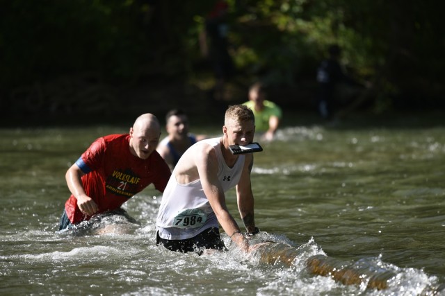 Competitors traverse the Big Piney River Saturday before crossing the finish line at Happy Hollow recreation area during the 21st Marine Corps Volkslauf 10k Mud Run. After a two-year hiatus due to the pandemic, more than 300 service members, civilians and family members took to the streets and trails of Fort Leonard Wood for the event. 