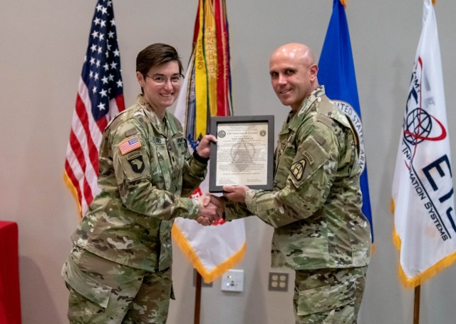 ARDAP Project Manager Col. Rob Wolfe (r.) presents Lt. Col. LJ Freeland (l.) with the charter for Army Data Platform.