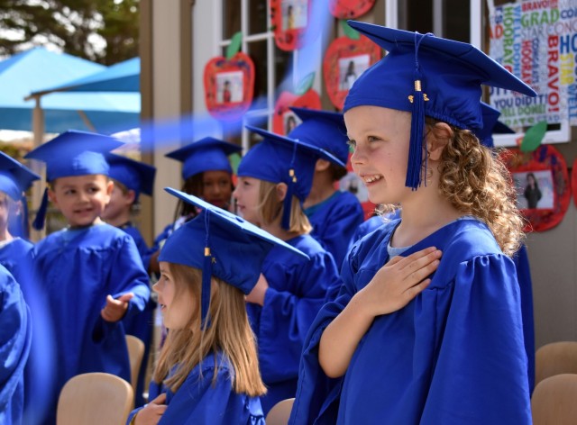A Strong Beginnings graduate stands ready for the Pledge of Allegiance during the program’s graduation ceremony at the Presidio of Monterey Child Development Center, Ord Military Community, Calif., June 3.