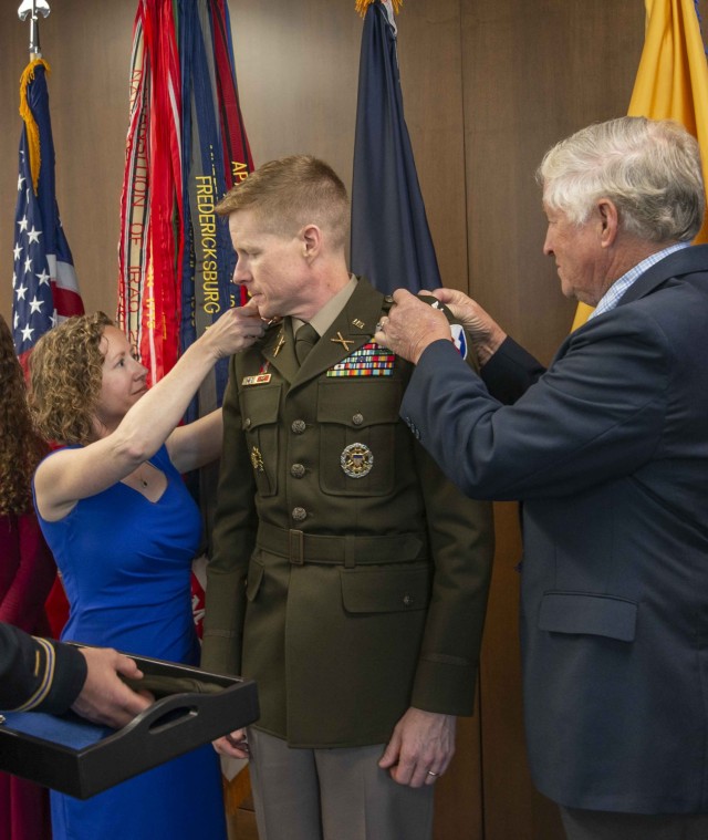 Col. Brad Nicholson (center), commander of the U.S. Army Security Assistance Command, is promoted to the rank of brigadier general during a June 9, 2022 ceremony at USASAC&#39;s Redstone Arsenal headquarters. He was pinned by (from left) his wife,...