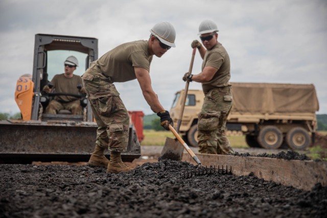 Air National Guard Airman First Class Cabrera, 124th Civilian Engineer Squadron, smooths out gravel as a part of an Innovative Readiness Training mission while building homes for the Cherokee Veterans Housing Initiative in Tahlequah, Oklahoma, June 6, 2022. IRT is a Department of Defense initiative that is a joint environment with National Guard Soldiers and Airmen. (Oklahoma National Guard photo by Sgt. Reece Heck)