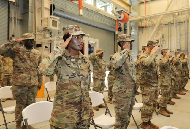 Fourteen noncommissioned officers assigned to the 35th Combat Sustainment Support Battalion render a salute during their induction ceremony into the NCO corps at Sagami General Depot, Japan, June 10, 2022. 
