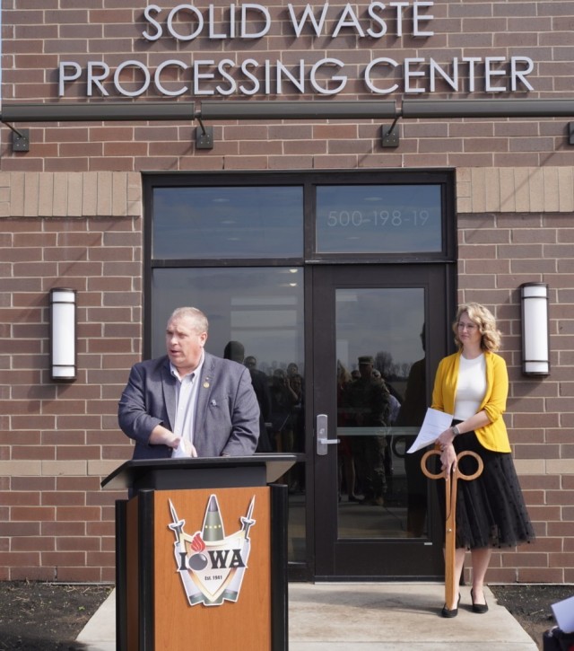 Bryan Bross, Klingner & Associates, P.C, addresses Iowa Army Ammunition Plant’s workforce and community members during the ribbon-cutting ceremony for the new facility while Ms. Jessi Mynatt, facilities engineering and program manager for American Ordnance, stands by his side.      