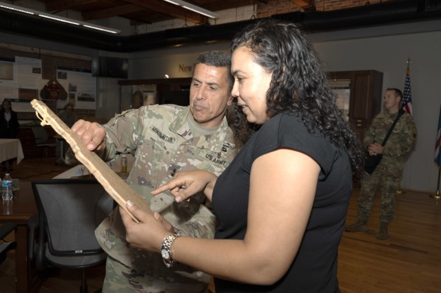 Maj. Gen. David Mikolaities, New Hampshire adjutant general, left, presents Cabo Verde Minister of Defense Janine Lélis with an intricately carved map of the state at the end of a State Partnership Program workshop in Concord, New Hampshire, June 10, 2022. Lélis and delegates from the African archipelagic country discussed NHNG capabilities and opportunities to work together. (U.S. Air National Guard photo by Tech. Sgt. Charles Johnston)