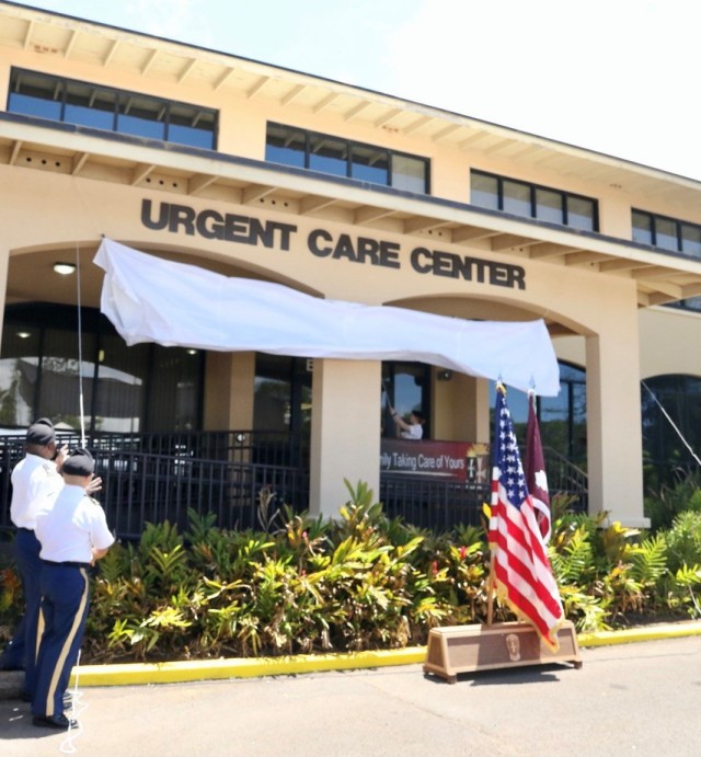 Col. Randall Freeman, Deputy Commander for Clinical Services, Desmond T. Doss Health Clinic and Maj. Keith Barry Garcia, Officer in Charge of the Urgent Care Center, Desmond T. Doss Health Clinic, unveil the newly designated Urgent Care Center. After two years of inspections, process improvements, and workload realignment, Desmond T. Doss Health Clinic earned accreditation by the Urgent Care Association.  