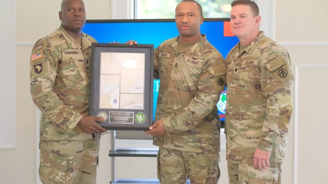 Lt. Col. Tyler Olsen, commander, 842nd Transportation Bn. andSgt. Maj. Cherry present a token of appreciation to Command Sgt. Maj. Lonnie Gabriel during a farewell luncheon at the Fort Eustis Club at Joint Base Langley-Eustis, Va. June 9.