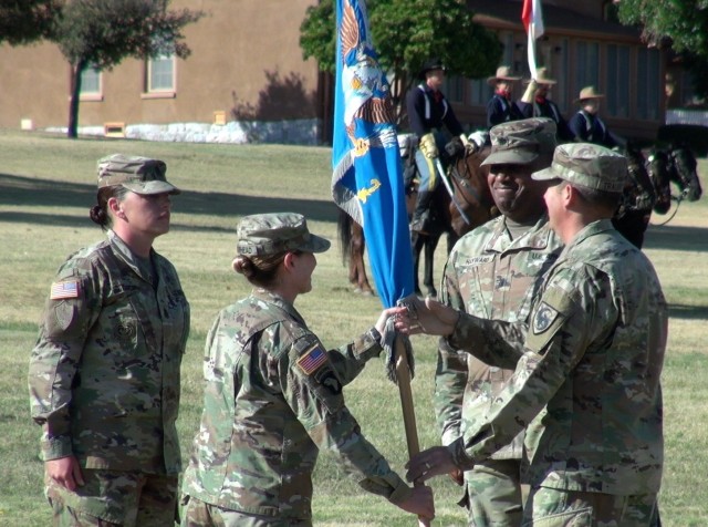 (right ) Col. Loren Traugutt, Commander 111th Military Intelligence Brigade, passes the unit colors to Lt. Col Laura Muirhead,  Incoming Commander, 309th Military Intelligence Battalion as Lt Col. Dartanion Hayward, Outgoing Commander, 309th Military Intelligence Battalion looks on at a Change of Command ceremony at Fort Huachuca, Ariz.