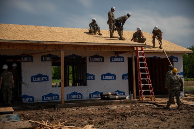 Oklahoma National Guard Soldiers with the 2120th Engineer Company, 120th Engineer Battalion, 90th Troop Command, work on a roof as a part of an Innovative Readiness Training mission while building homes for the Cherokee Veterans Housing Initiative in Tahlequah, Oklahoma, June 6, 2022. They are able to directly help Oklahomans thanks in part to the IRT – a Department of Defense initiative that is a joint environment with National Guard Soldiers and Airmen. (Oklahoma National Guard photo by Sgt. Reece Heck)