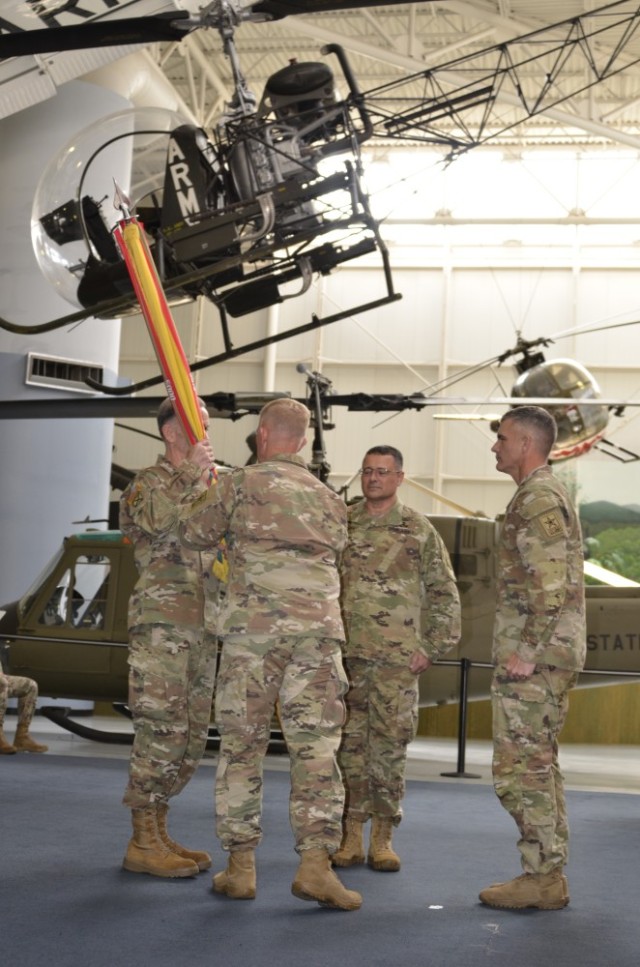 Lt. Gen. Walter Piatt (left), director of the Army Staff, receives the U.S.
Army Combat Readiness Center colors from Brig. Gen. Andrew Hilmes, outgoing commander of the USACRC, before passing them to incoming commander Brig. Gen. Gene Meredith. Command Sgt. Maj. James Light (right) observes the passing of the colors. 