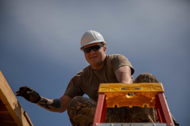 Sgt. Jason Hunnicutt, 2120th Engineer Company, 120th Engineer Battalion, 90th Troop Command, Oklahoma Army National Guard works on a roof as a part of an Innovative Readiness Training mission while building homes for the Cherokee Veterans Housing...