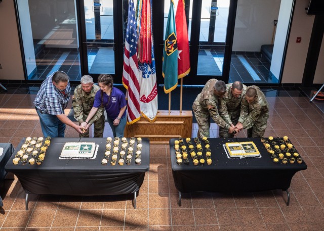Maj. Gen. James Bonner, Maneuver Support Center of Excellence and Fort Leonard Wood commanding general (second from left), and MSCoE and Fort Leonard Wood Command Sgt. Maj. Randolph Delapena (second from right) participate in a traditional Army cake-cutting ceremony Tuesday in the Hoge Hall foyer as part of Fort Leonard Wood&#39;s Army Birthday celebrations. Two cakes were set out, and this year, the longest- and shortest-tenured Army civilians on Fort Leonard Wood joined Bonner in cutting one cake, while the oldest and youngest Soldiers on Fort Leonard Wood joined Delapena in cutting the second cake. The longest-tenured Army civilian was David Kane from the Directorate of Public Works (left), and Kirra Reddick (third from left), from the Directorate of Family and Morale, Welfare and Recreation, was the shortest-tenured Army civilian. The oldest Soldier was U.S. Army Garrison Fort Leonard Wood Chaplain (Lt. Col.) Walter Marshall (third from right), and the youngest Soldier was Pvt. Karter Gil (right), from Company B, 35th Engineer Battalion.