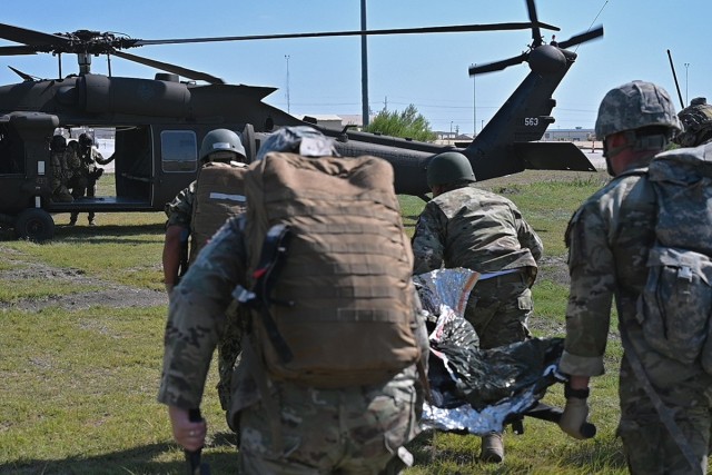 Joint medical learners participating in an aeromedical care course transport a simulated casualty to a UH-60 Black Hawk helicopter, 1-244th Assault Helicopter Battalion, Louisiana Army National Guard, during the 2022 Joint Emergency Medicine Exercise at Fort Hood, Texas, June 9, 2022. The JEMX at the Carl R. Darnall Army Medical Center brought together over 2,000 service members from across the services to train medical personnel in combat casualty care, aeromedical care and forward resuscitation surgical team care. (U.S. Air National Guard Photo by Master Sgt. Toby Valadie)