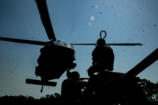 U.S. Army Soldiers with the 4th Battalion, 3rd Aviation Brigade, and the Bravo Battery, 1st Battalion, 118th Field Artillery Regiment, conduct sling-load operations at Fort Stewart, Ga., June 14, 2022. The Exportable Combat Training Capability exercise includes approximately 4,400 brigade personnel from throughout Georgia. (U.S. Army photo by Sgt. Tori Miller)
