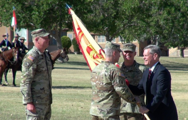 (right) Vincent Grewatz, Director, U.S. Army Installation Management Command-Training passes the unit colors to  Col John Ives,  Incoming Commander, U.S. Army Garrison-Fort Huachuca as  Col. Jarrod Moreland,  Outgoing Commander looks on at a Change of Command ceremony at Fort Huachuca, Ariz.