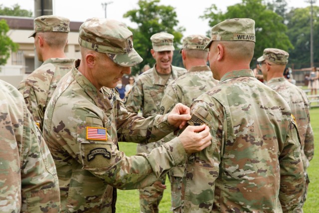 Command Sgt. Maj. Jerry Dodson Jr., senior enlisted leader for U.S. Army Japan, places a new patch on a Soldier during a ceremony at Camp Zama, Japan, June 17, 2022. The patch, which combines both the U.S. and Japan flags, symbolizes their enduring bilateral relationship.