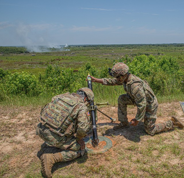 Georgia Army National Guard Spcs. Seth Fox, left, and Kwasi Fowler, indirect fire infantrymen assigned to tA Company, 1st Battalion, 121st Infantry Regiment, 48th Infantry Brigade Combat Team, execute fire missions during the 48th IBCT&#39;s Exportable Combat Training Capability exercise at Fort Stewart, Ga, June 15, 2022. The exercise included approximately 4,400 brigade personnel from throughout Georgia. (U.S. Army Georgia National Guard photo by Sgt. Victor Everhart Jr.)