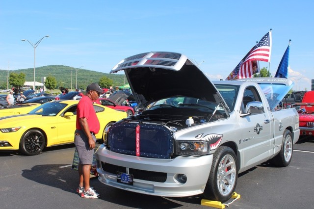 Jai Johnson, a program analyst at the Missile Defense Agency, looks at the Cruise-In Car Show entries.
