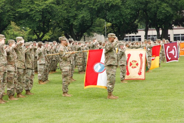 U.S. Soldiers and Japan Ground Self-Defense Force members render salutes while in formation during a patching ceremony at Camp Zama, Japan, June 17, 2022.