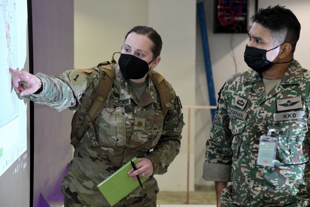 U.S. Army Maj. Jennifer Erickson, Bersama Warrior 2022 Surgeon, coordinates with her Malaysian Army counterpart during the eighth annual Bersama Warrior exercise in Kuantan, Malaysia, June 8, 2022. Bersama Warrior is an annual joint and bilateral exercise sponsored by U.S. Indo-Pacific Command and hosted by the Malaysian Armed Forces. (Photo courtesy of Malaysian Armed Forces)