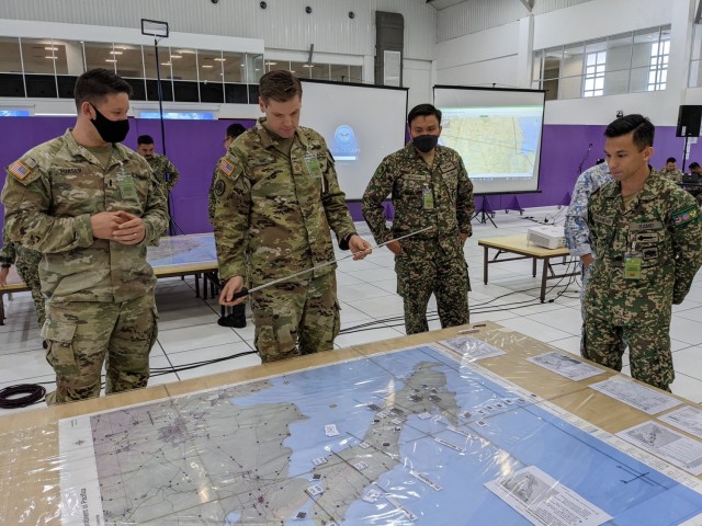 U.S. Army and Malaysian Army personnel collectively plan to conduct operations against a fictitious enemy during the eighth annual Bersama Warrior exercise in Kuantan, Malaysia, June 12, 2022. Bersama Warrior is an annual joint and bilateral exercise sponsored by U.S. Indo-Pacific Command and hosted by the Malaysian Armed Forces. (National Guard photo by Lt. Col. Alyson Teeter)