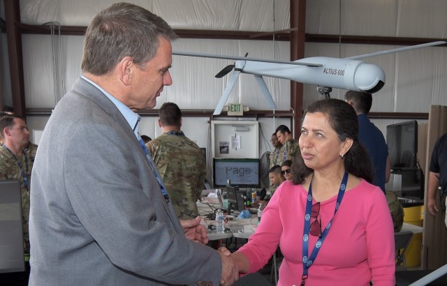 DEVCOM AvMC Director Jeff Langhout presents a director&#39;s coin to Dr. Jay Moorthy at EDGE22.