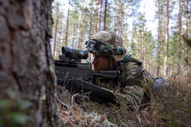 U.S. Army Soldier Pfc. Pierce English lines up his sight during Exercise Arrow 22