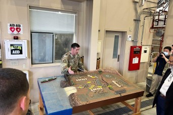 Maj. Shane Gregory, chief of activity, Army Field Support Battalion-Northeast Asia (Forward), Sagami General Depot, Japan, describes Army Prepositioned...
