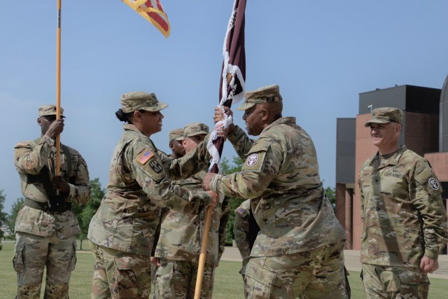 Col. Stacey Amos (left foreground), incoming commander of General Leonard Wood Army Community Hospital, receives the unit colors from Brig. Gen. Shan Bagby, Regional Health Command-Central commander at Joint Base San Antonio-Fort Sam Houston,...