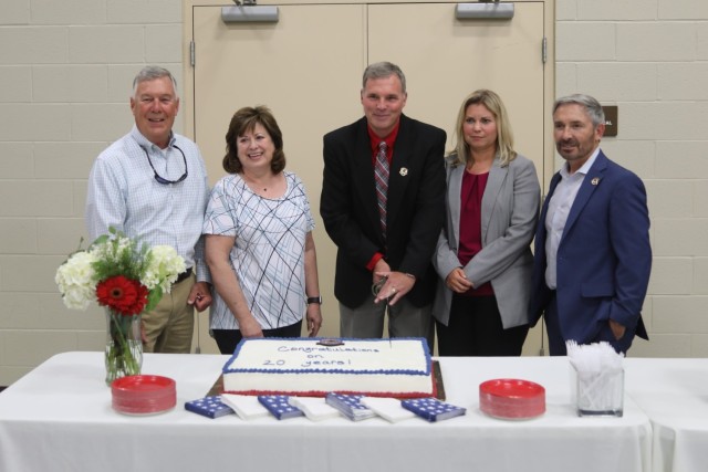 Current and former leaders cut the cake at the DEVCOM AvMC Prototype Integration Facility 20th anniversary celebration. From left are Dave Elder, Patti Martin, Allen Waldran, Miranda Oden and Danny Featherston.