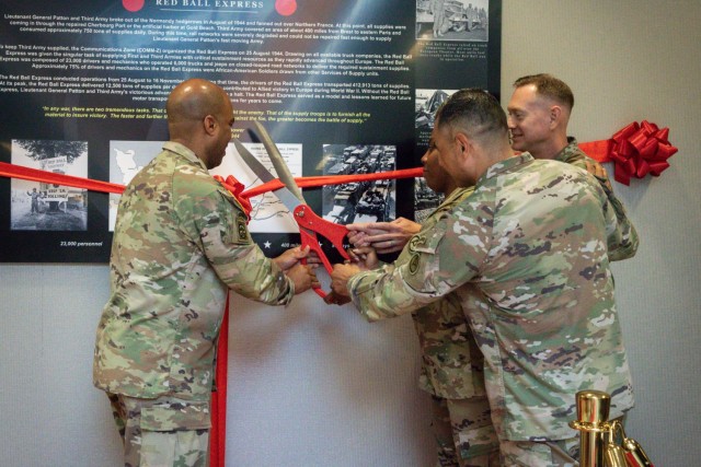 The USARCENT Command Team and Senior leaders from the USARCENT Logistics team cut the ribbon to commemorate the reveal of the Red Ball Express monograph at Patton Hall on June 03, 2022. The Red Ball Express historical display is the latest addition to the many exhibits in Patton Hall. The monograph depicts the heroic actions of the Red Ball Express during WWII.
