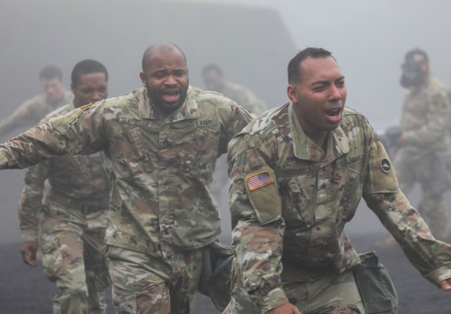 Sgt. Jamal Slaughter, center left, and Sgt. Nowell Vasquez exit a gas chamber during a training event at the Combined Arms Training Center Camp Fuji, Japan, June 23, 2022. More than 60 Soldiers assigned to the 35th Combat Sustainment Support Battalion participated in the training, as part of a larger effort to increase readiness in the battalion.