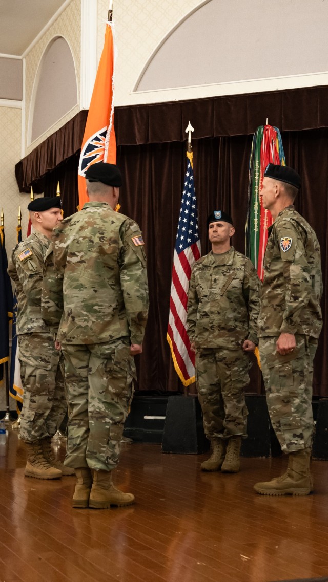 Brig. Gen. Charles R. &#34;Rob&#34; Parker takes the colors of the 7th Signal Command (Theater),  during a change of command ceremony at Club Meade on Fort George G. Meade, Maryland, June 22, 2022.