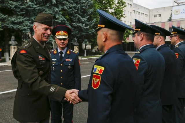 Army Gen. Daniel Hokanson, chief of the National Guard Bureau, is greeted by a Moldovan military band at the Ministry of Defense headquarters in Chisinau, Moldova, June 10, 2022. Hokanson joined Army Maj. Gen. Todd Hunt, the adjutant general of the North Carolina National Guard, to recognize Moldova&#39;s 23-year security cooperation with North Carolina.
