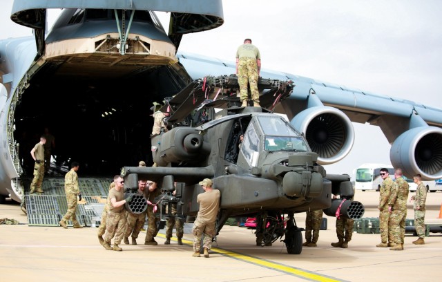 U.S. Soldiers from the 1-211th Aviation Regiment, Utah Army National Guard, unload an AH-64 Apache helicopter on June 20, 2022, at Agadir Al-Massira International Airport, Morocco. AL22 is U.S. Africa Command's largest, premier, joint, combined annual exercise hosted by Morocco, Ghana, Senegal, and Tunisia, June 6 - 30. More than 7,500 participants from 28 nations and NATO train together with a focus on enhancing readiness for U.S. and partner-nation forces. AL22 is a joint all-domain, multi-component, and multinational exercise, employing a full array of mission capabilities with the goal to strengthen interoperability among participants and set the theater for strategic access. (U.S. Army National Guard photo by Spc. Christopher Hall)