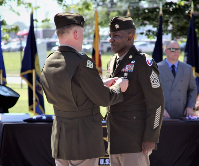 Maj. Gen. Darren Werner (left), commanding general, U.S. Army Tank-automotive and Armaments Command, places a  Soldier for Life Retirement pin  onto Command Sgt. Maj. Jerry Charles’ uniform during a retirement ceremony held at Detroit Arsenal June 24 for Charles. 
